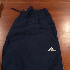 Adidas wind pants lined with mesh.
